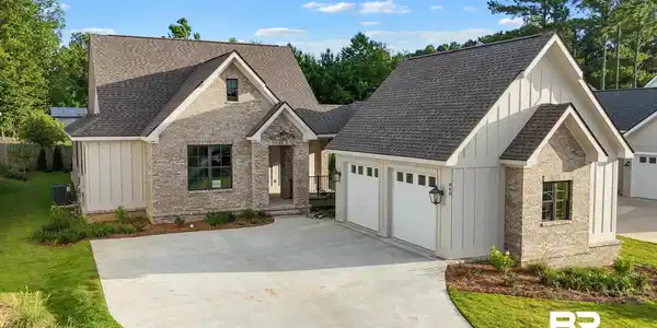 Image 2: Contemporary architectural design featuring a blend of light-toned brick and vertical board-and-batten siding