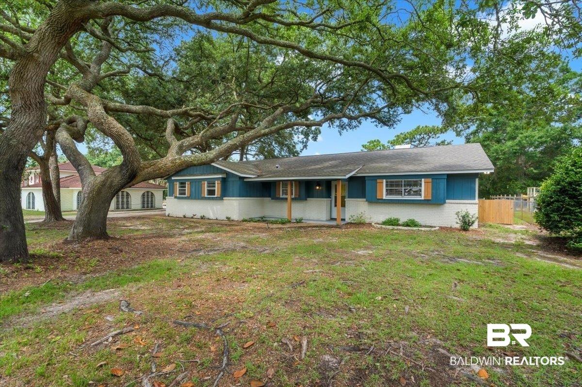 Image 3: Ranch-style residence featuring a blue and white exterior with shuttered windows
