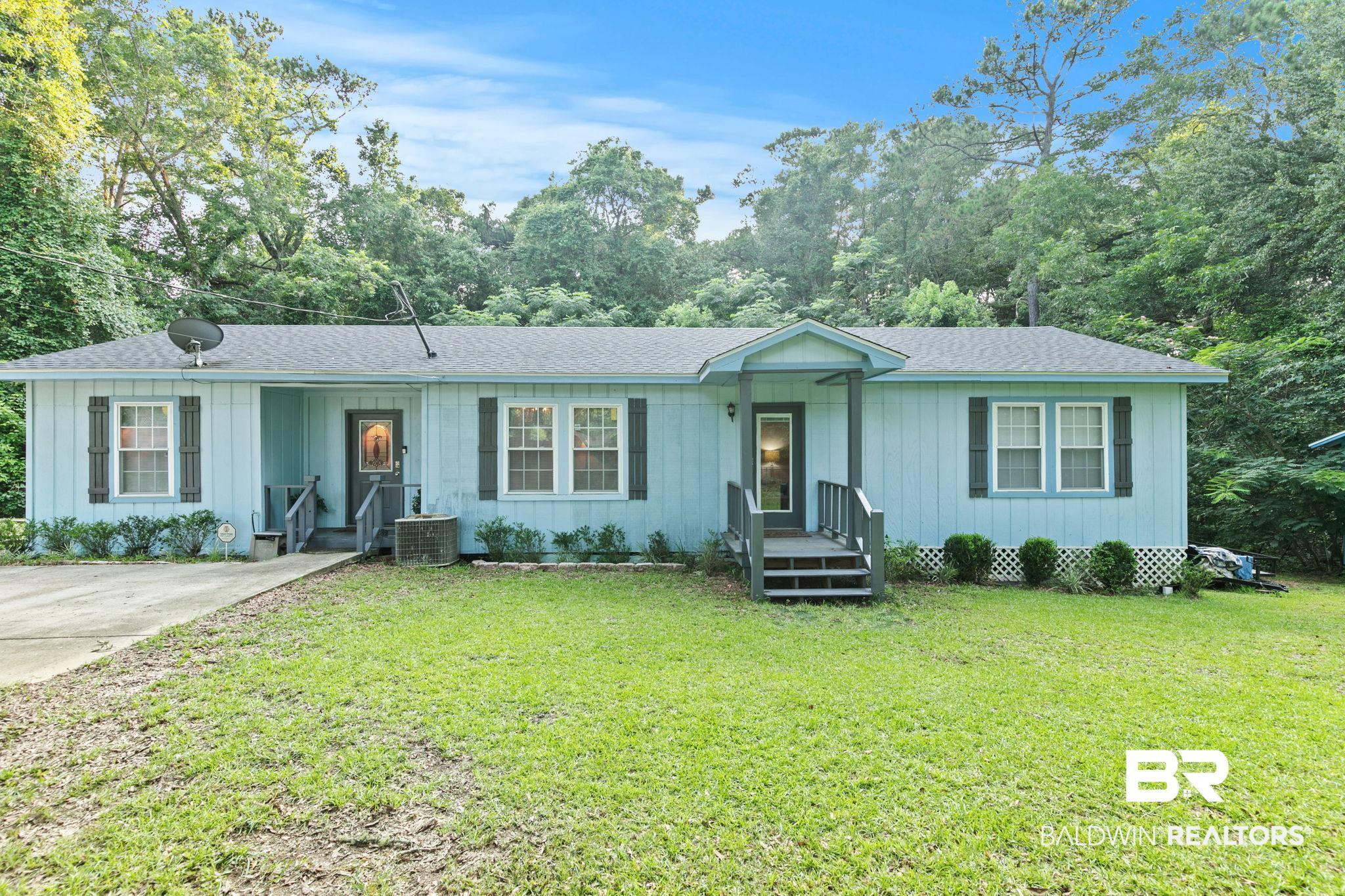 Image 3: Light blue siding exterior with a dark shingle roof