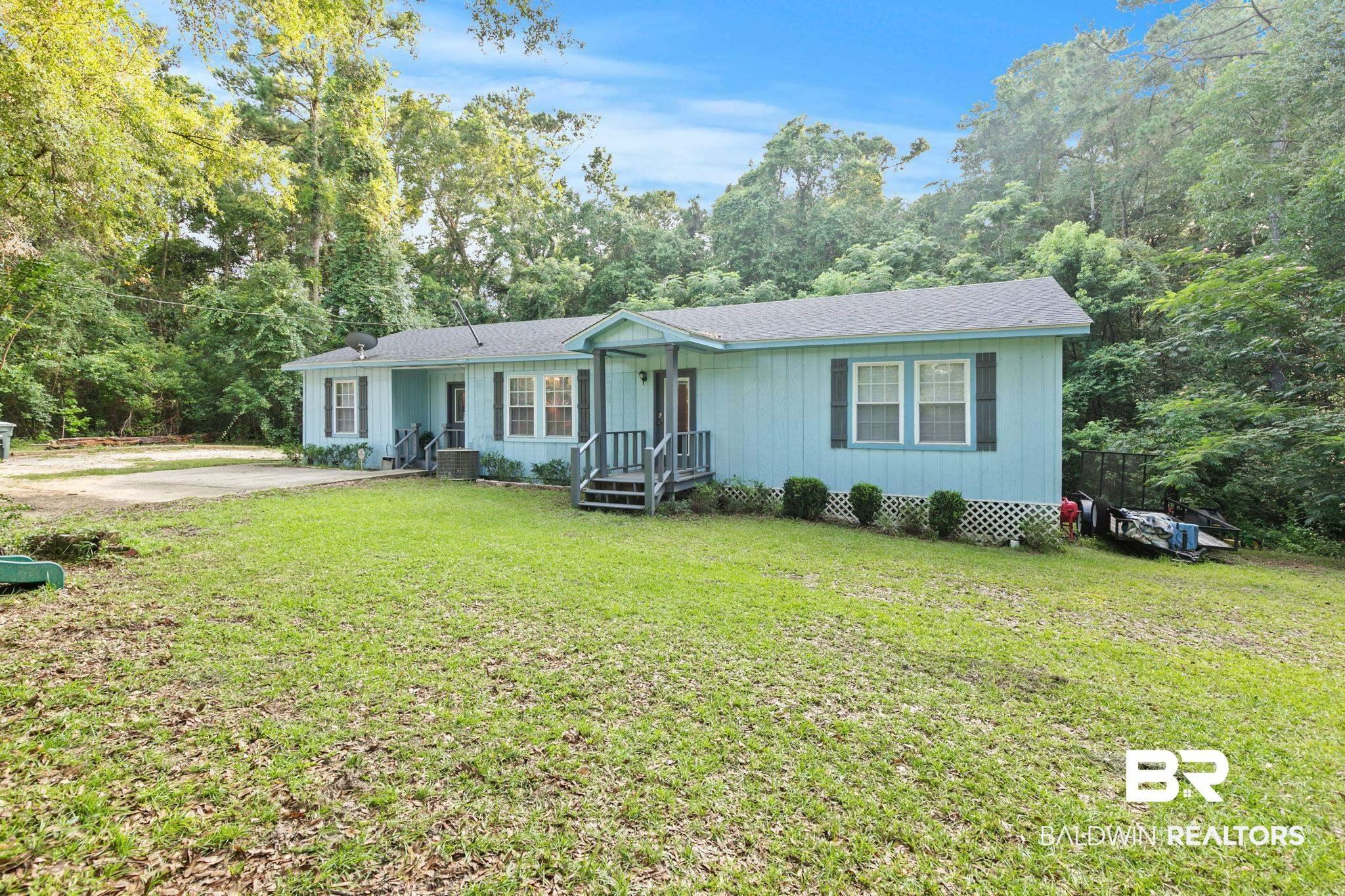 Image 4: Light blue exterior with dark shutters