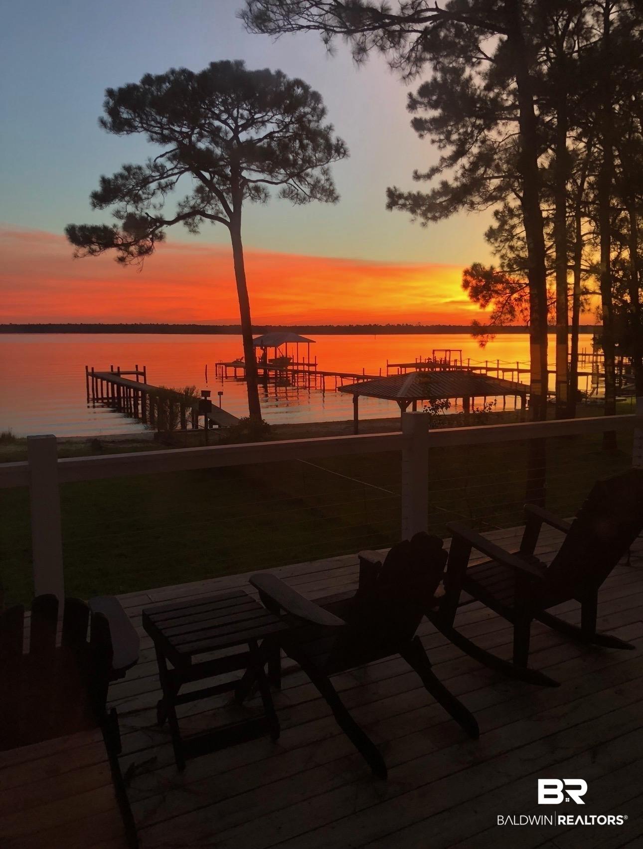 Image 4: Waterfront property featuring extensive private decking with multiple boat slips