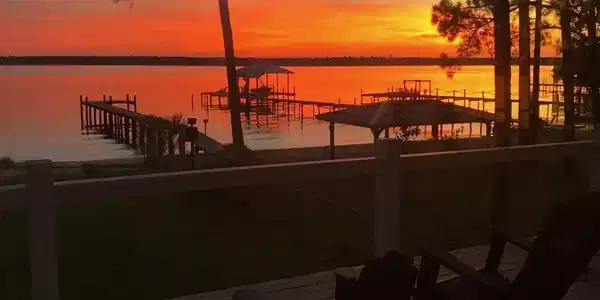 Image 4: Waterfront property featuring extensive private decking with multiple boat slips