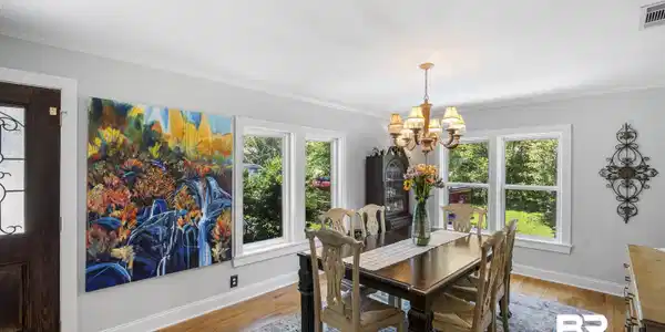 Image 4: Dining space featuring wood-finish flooring, white crown molding, and multiple windows