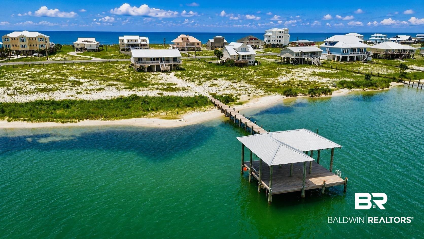 Image 2: Waterfront property featuring a private covered boat dock, direct water access, and a sandy shoreline