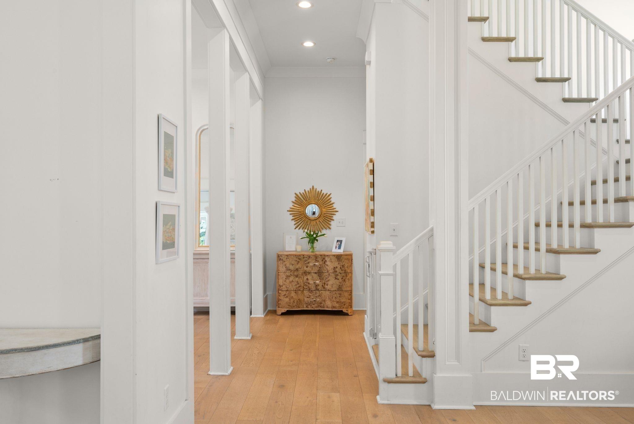 Image 4: Hardwood flooring throughout a spacious hallway with recessed lighting