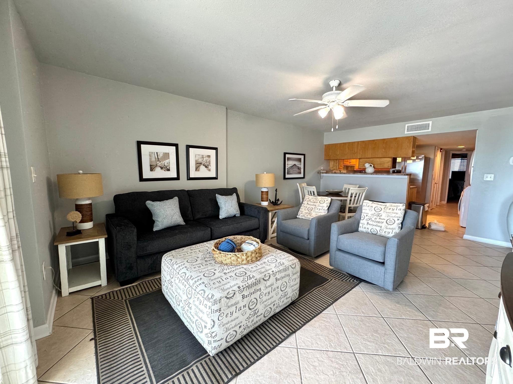 Image 4: Living room featuring ceiling fan and light tile patterned flooring