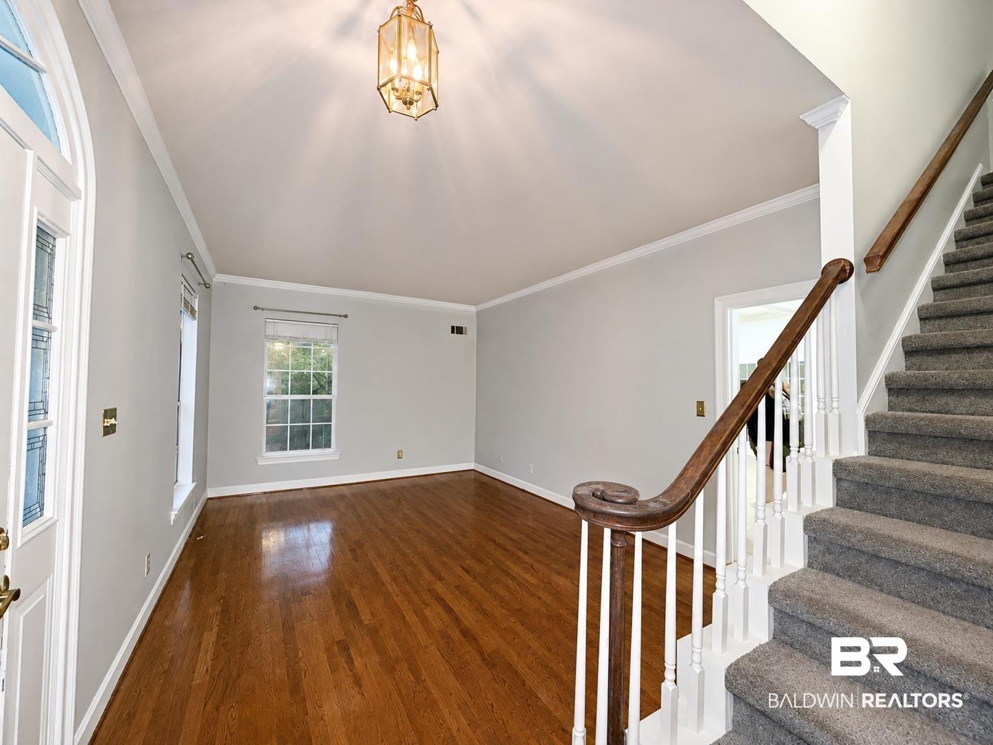 Image 2: Entry foyer featuring a vaulted ceiling and an ornate overhead light fixture