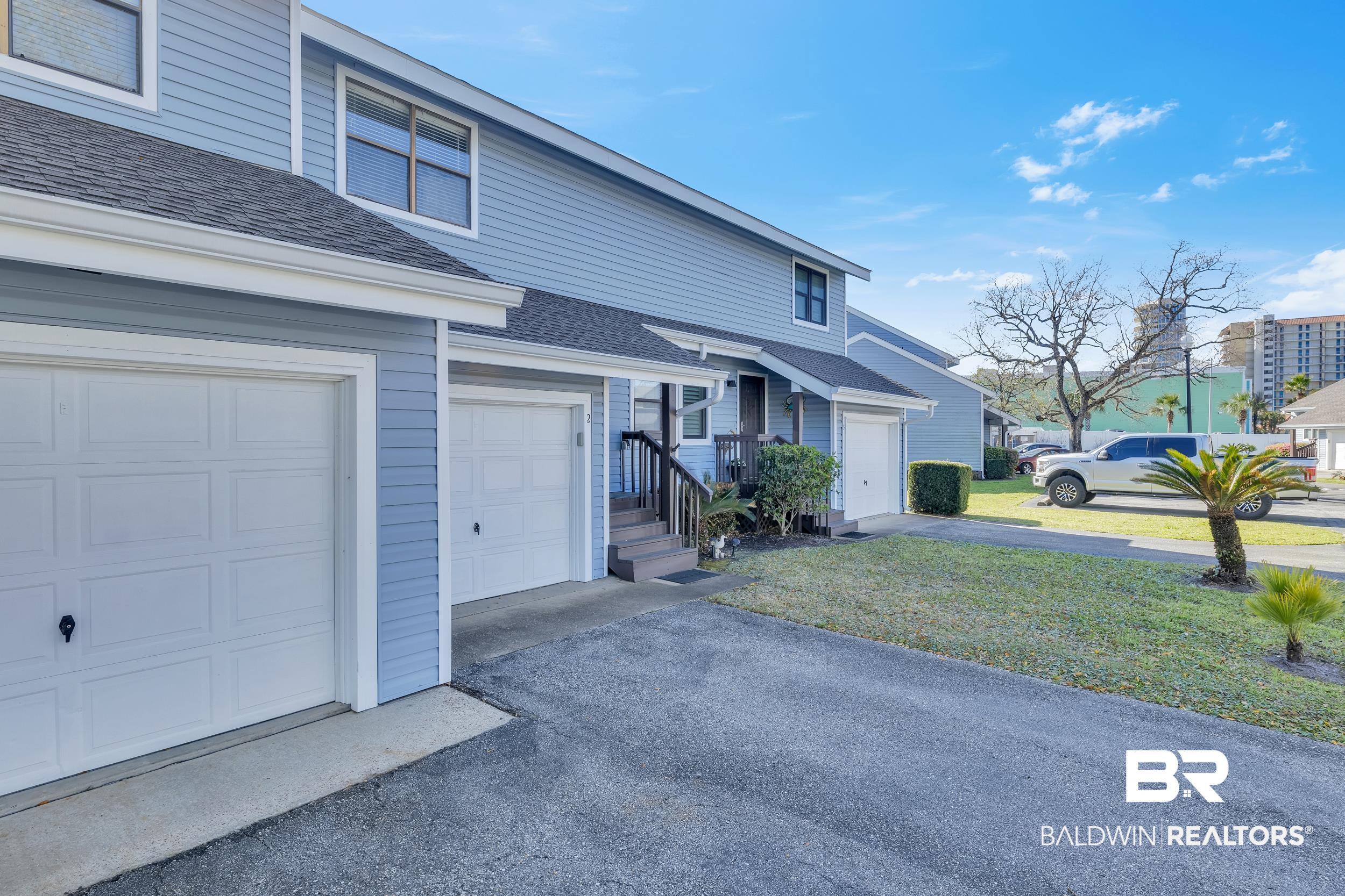 Image 2: Light blue siding exterior featuring white trim and multiple windows