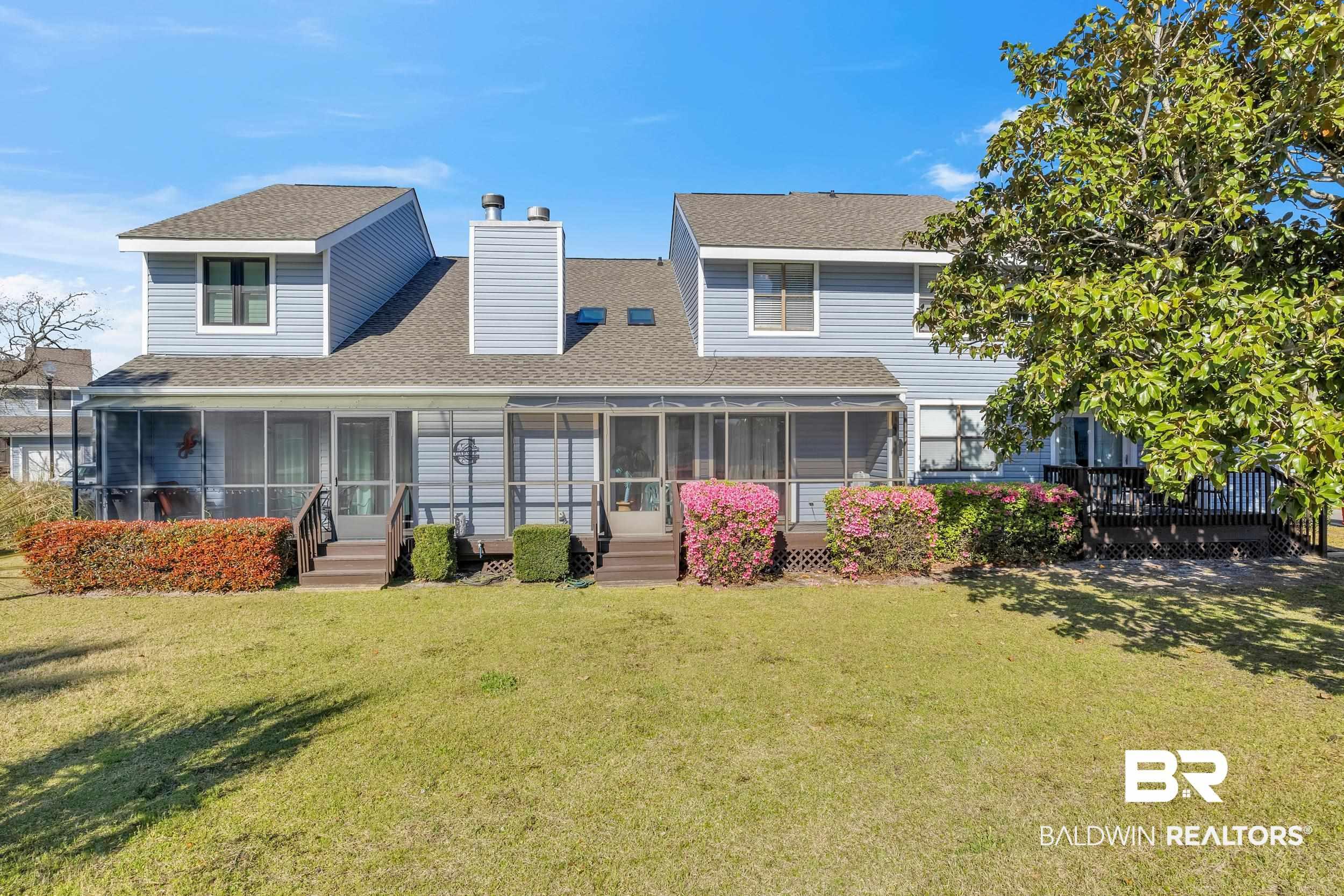 Image 4: Rear exterior featuring two screened porches, a private outdoor deck, siding facade, and a shingled roof