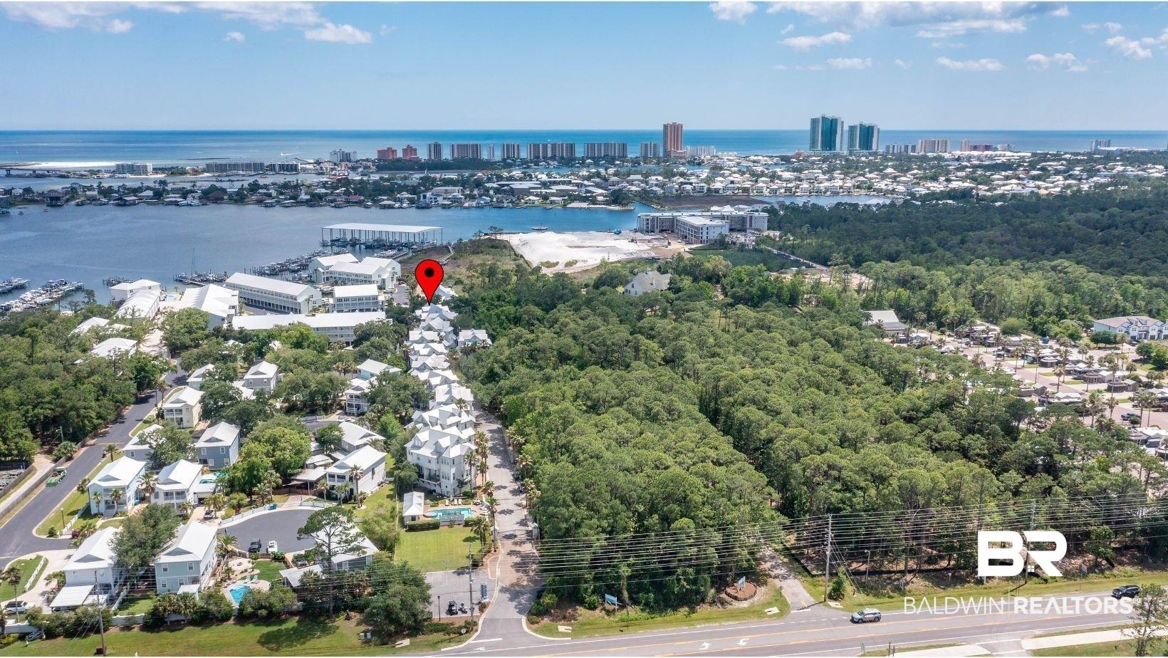 Image 4: Coastal community with water and city skyline in the background