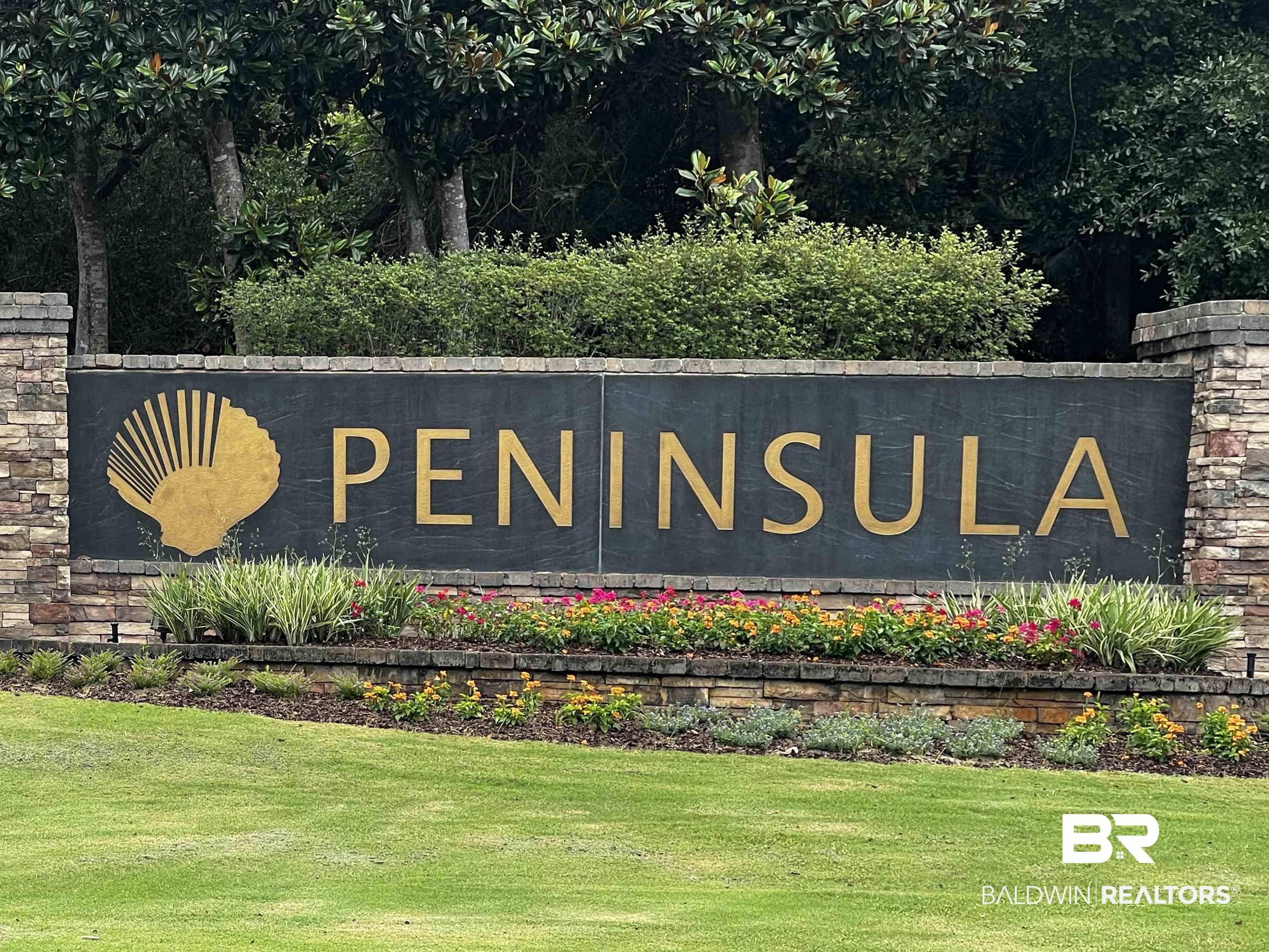 Image 2: Peninsula entrance sign featuring a stone facade, gold lettering, and a shell emblem