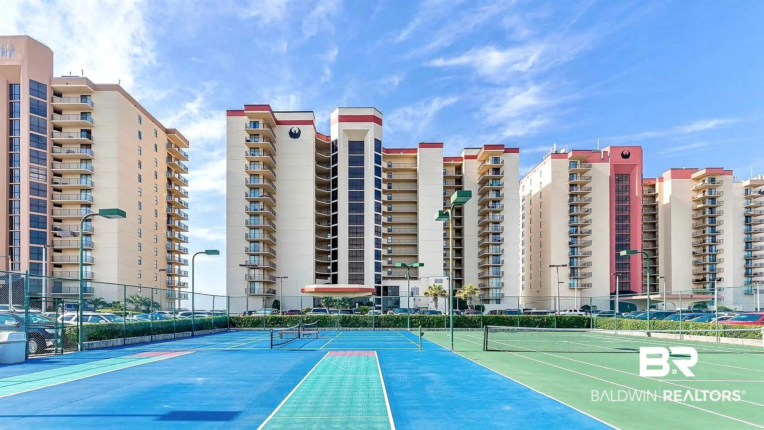 Image 1: Multi-court tennis facility featuring blue and green playing surfaces