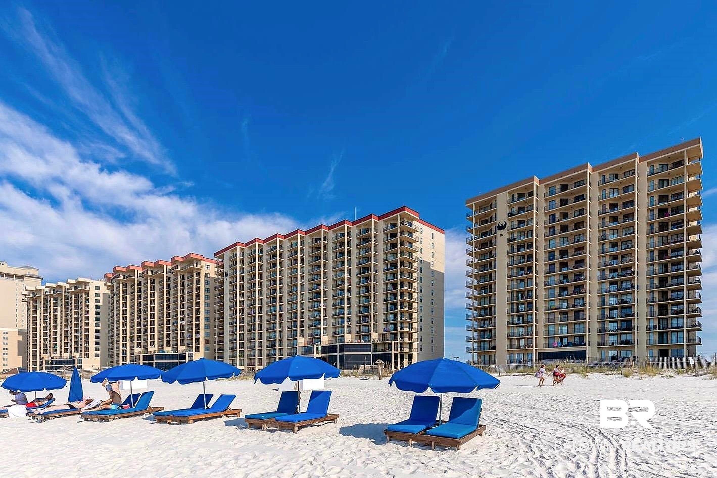 Image 2: Beachfront high-rise condominiums featuring multiple stories of private balconies
