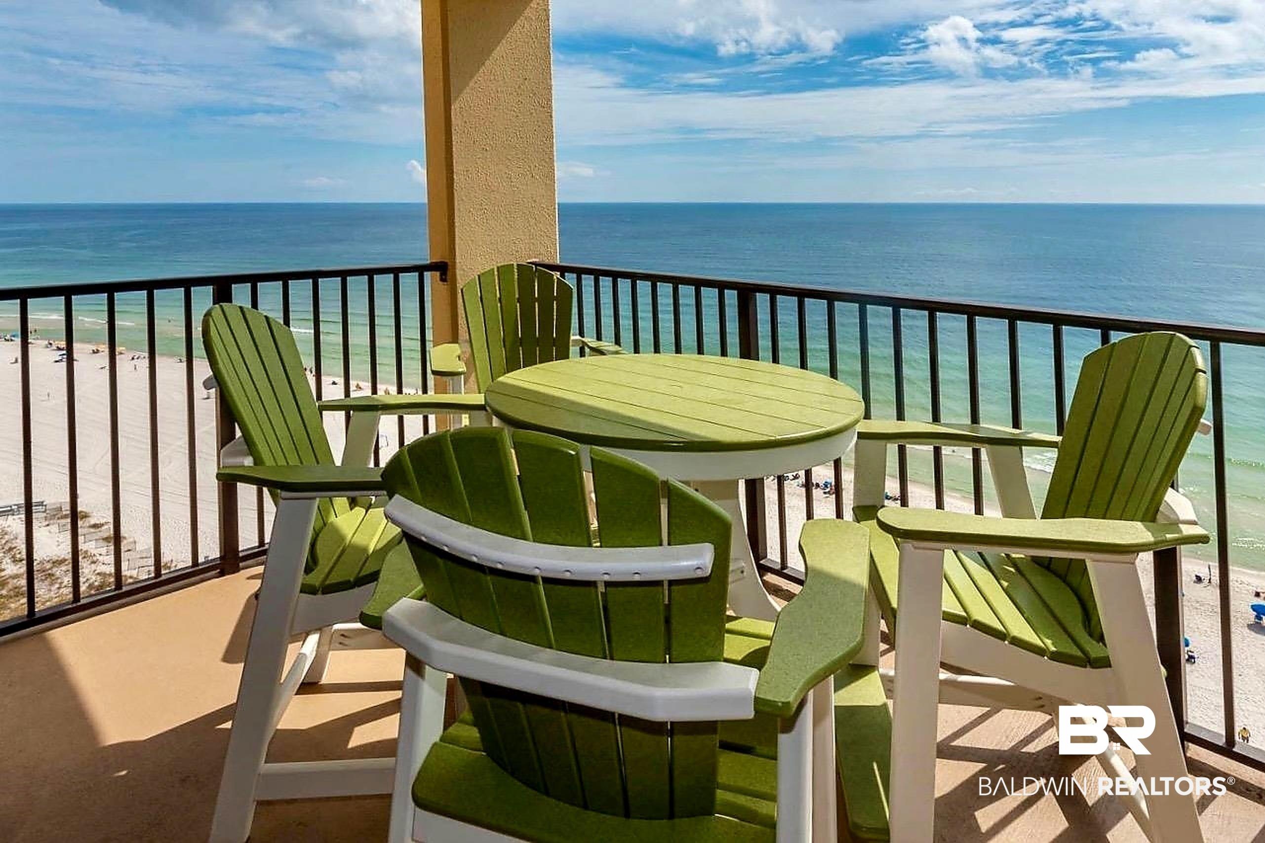 Image 3: Outdoor balcony featuring a stucco column, black metal railing, and a cement floor