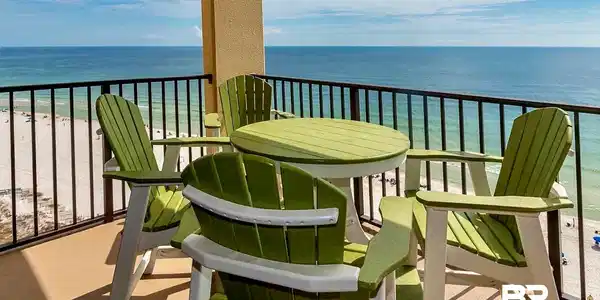 Image 3: Outdoor balcony featuring a stucco column, black metal railing, and a cement floor