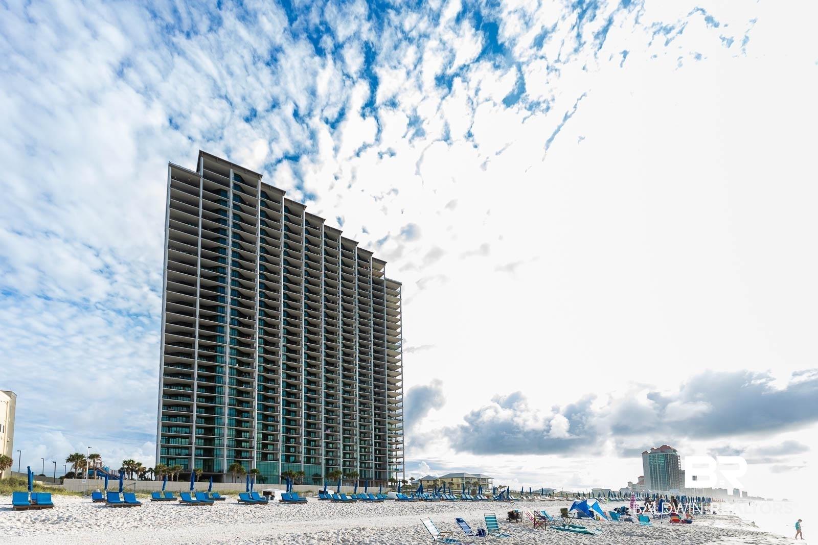 Image 1: View of building exterior featuring a water view