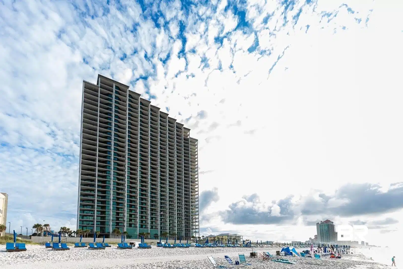 Image 1: View of building exterior featuring a water view