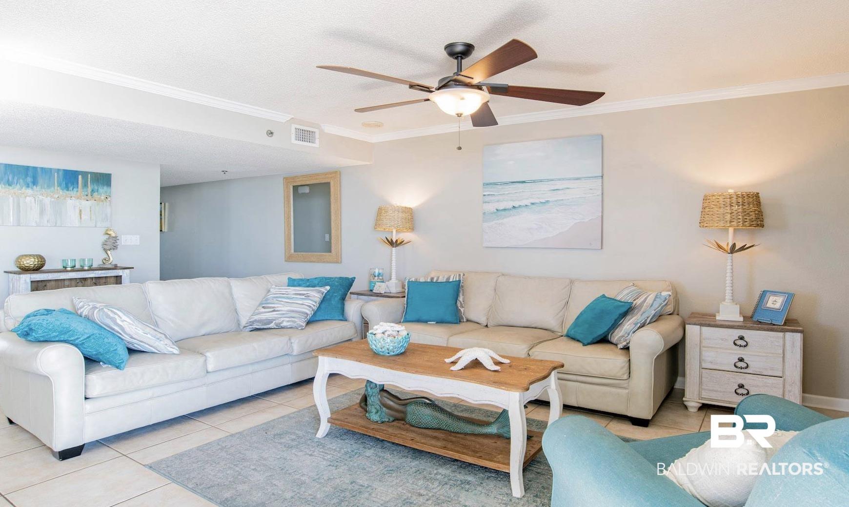 Image 3: Spacious living area featuring tile flooring and crown molding