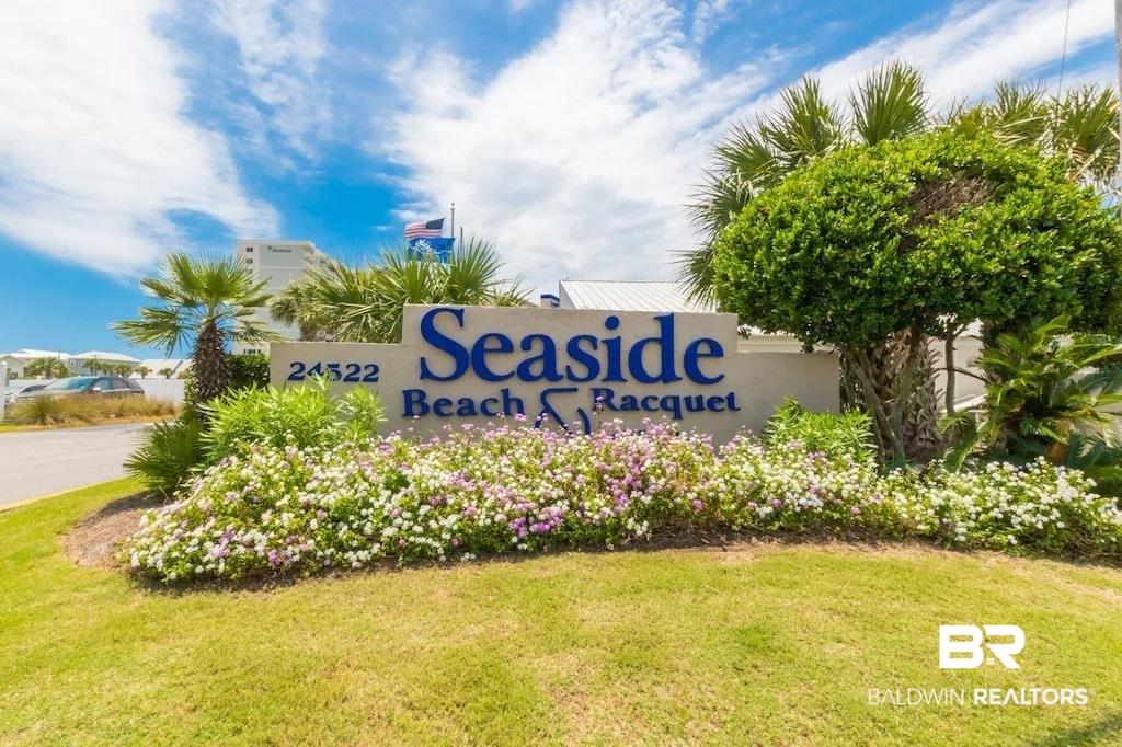 Image 2: Entryway signage featuring a concrete base with raised lettering, surrounded by manicured landscaping