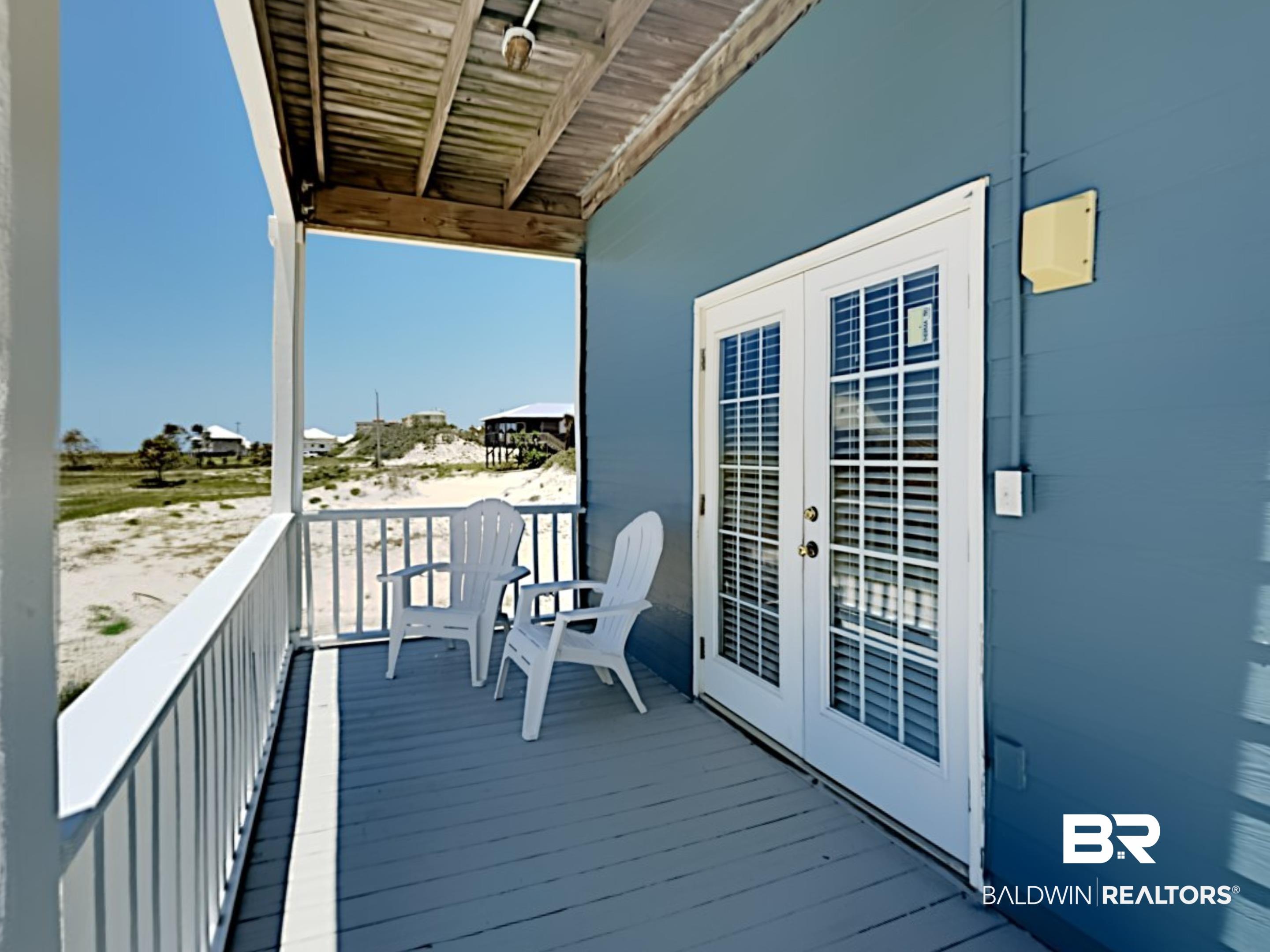 Image 3: Covered porch featuring a painted wood floor, white railing, and a tongue-and-groove wood ceiling