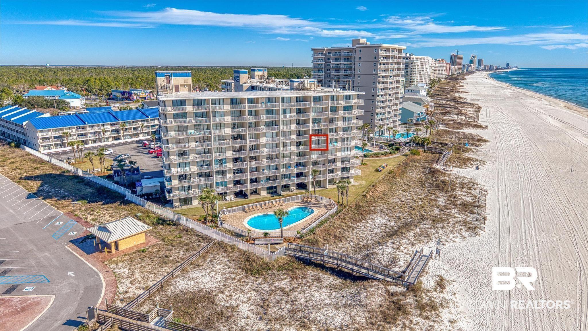Image 2: Drone / aerial view of a pool area and waterfront with a beach