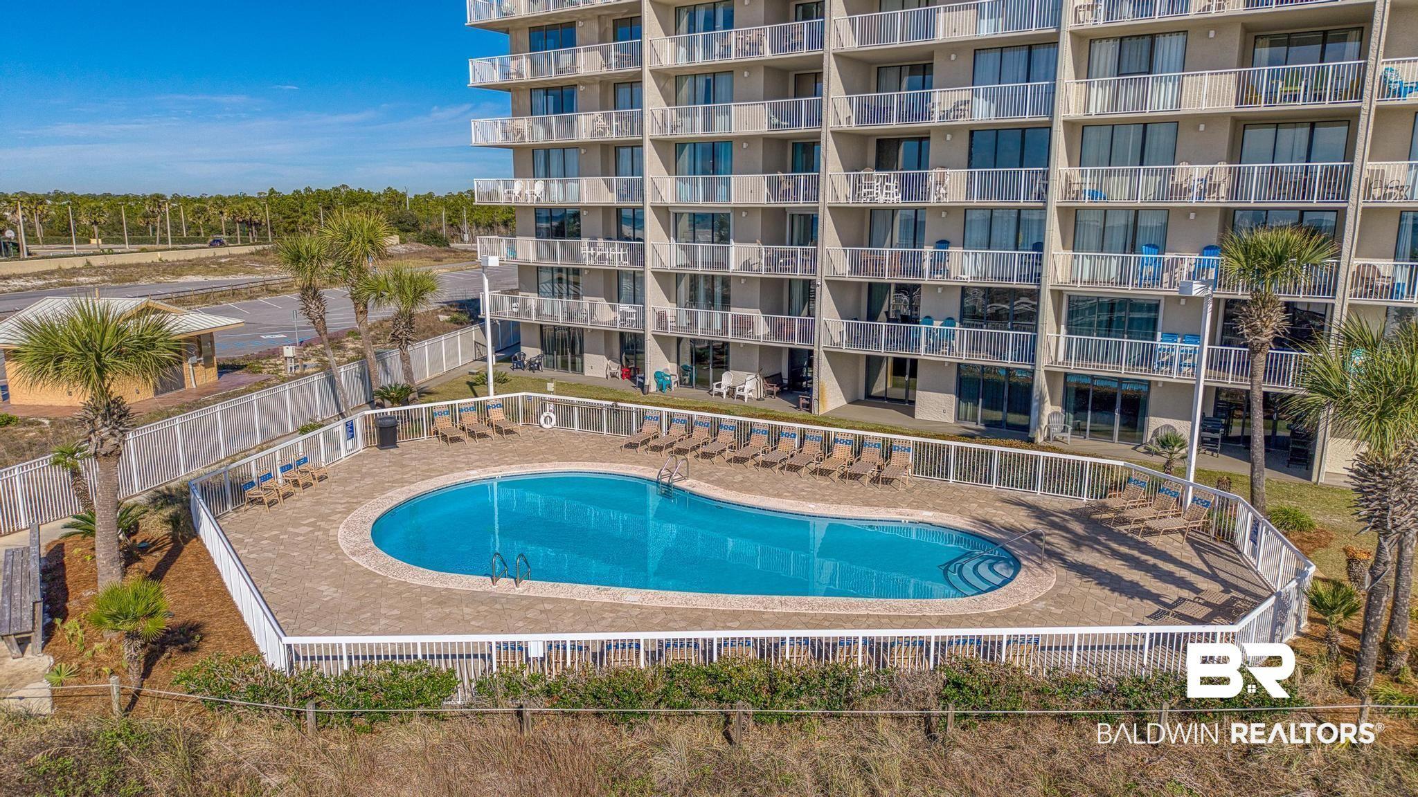 Image 4: Community pool with a patio area