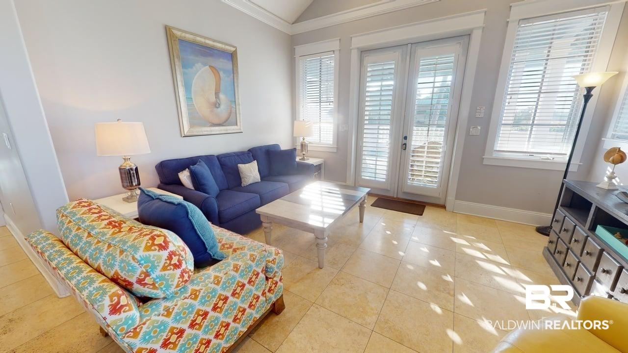 Image 2: Living room with lofted ceiling, french doors, and light tile patterned floors