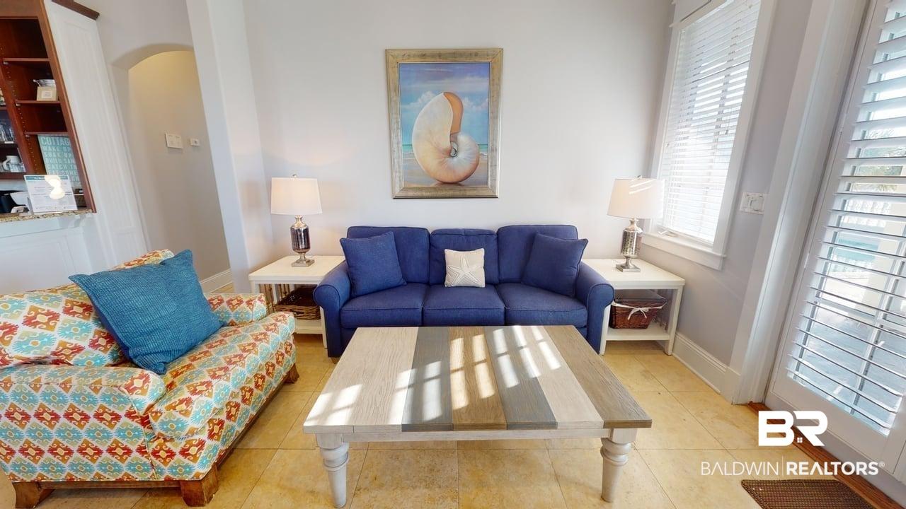 Image 3: Tiled living room featuring arched walkways and baseboards