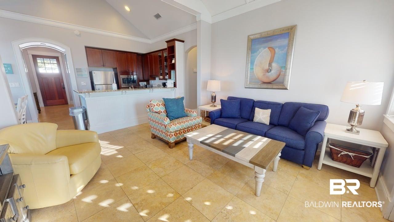 Image 4: Living area featuring arched walkways, ornamental molding, high vaulted ceiling, and light tile patterned floors