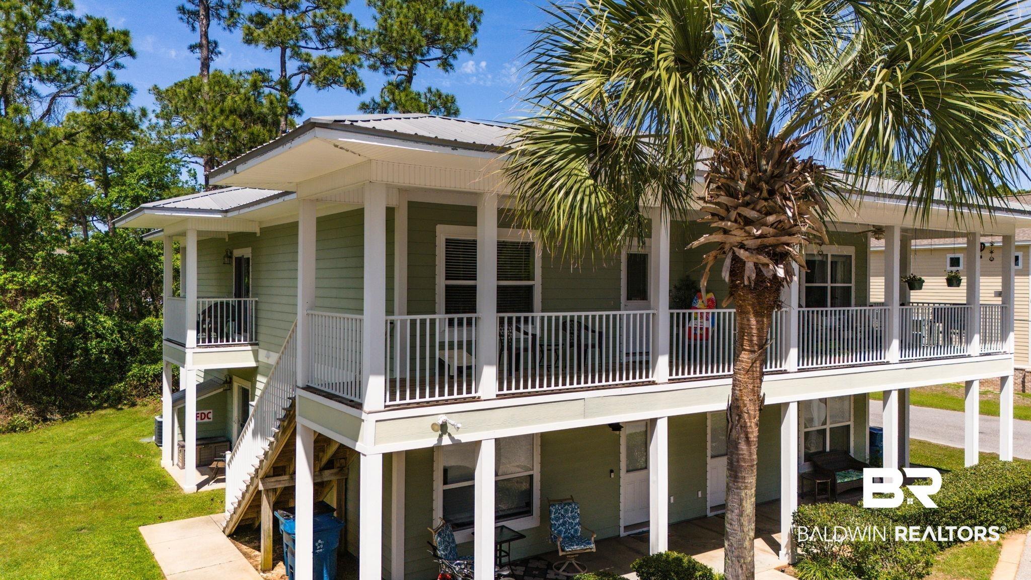 Image 3: View of side of home featuring a metal roof and a lawn