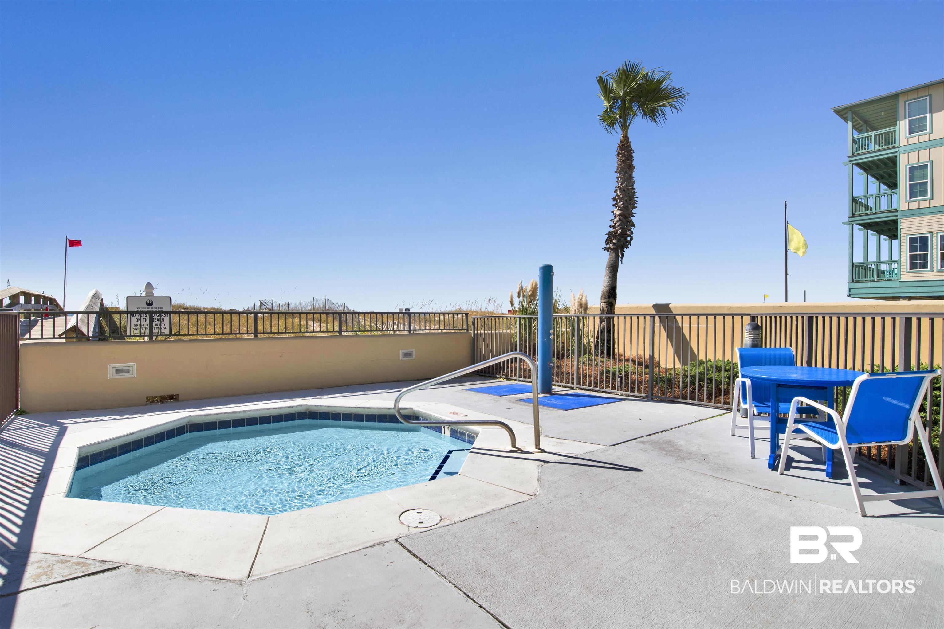Image 4: Octagonal hot tub featuring integrated steps and a surrounding concrete deck