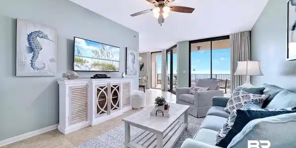 Image 2: Living room featuring a wall of windows, light tile patterned floors, and ceiling fan