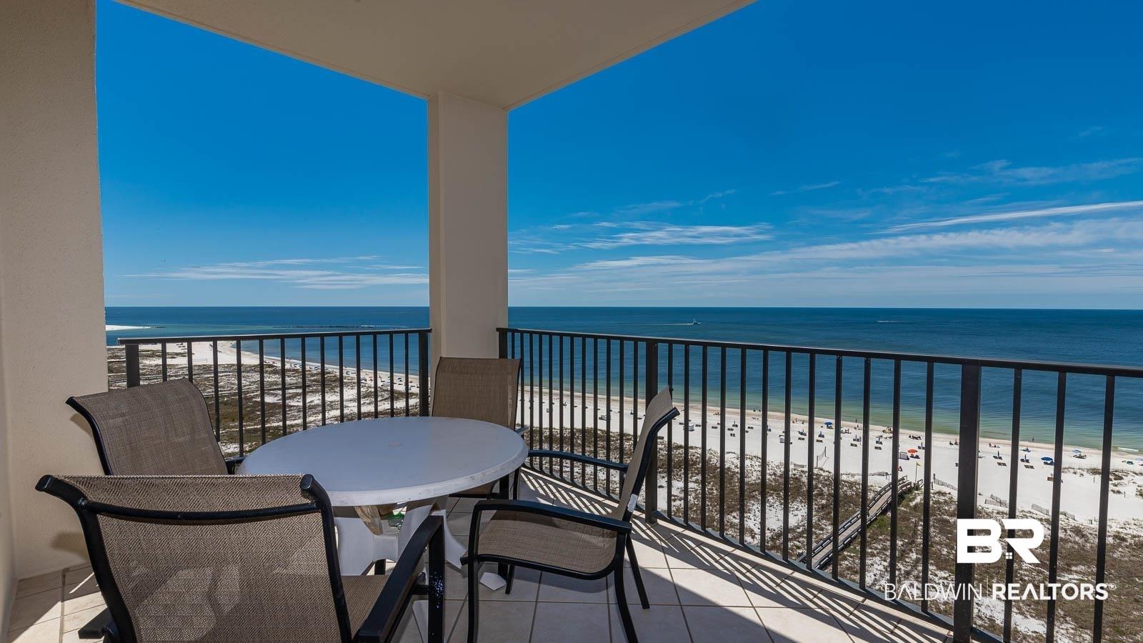 Image 2: Balcony featuring view of water and beach