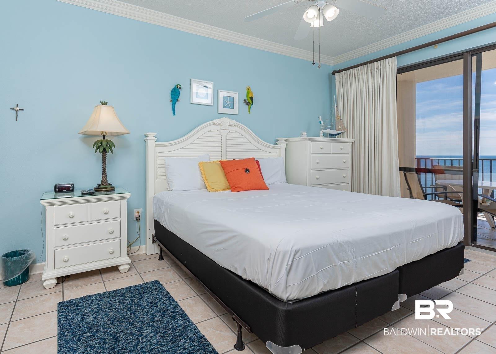 Image 4: Bedroom with access to outside, crown molding, light tile patterned flooring, ceiling fan, and a water view