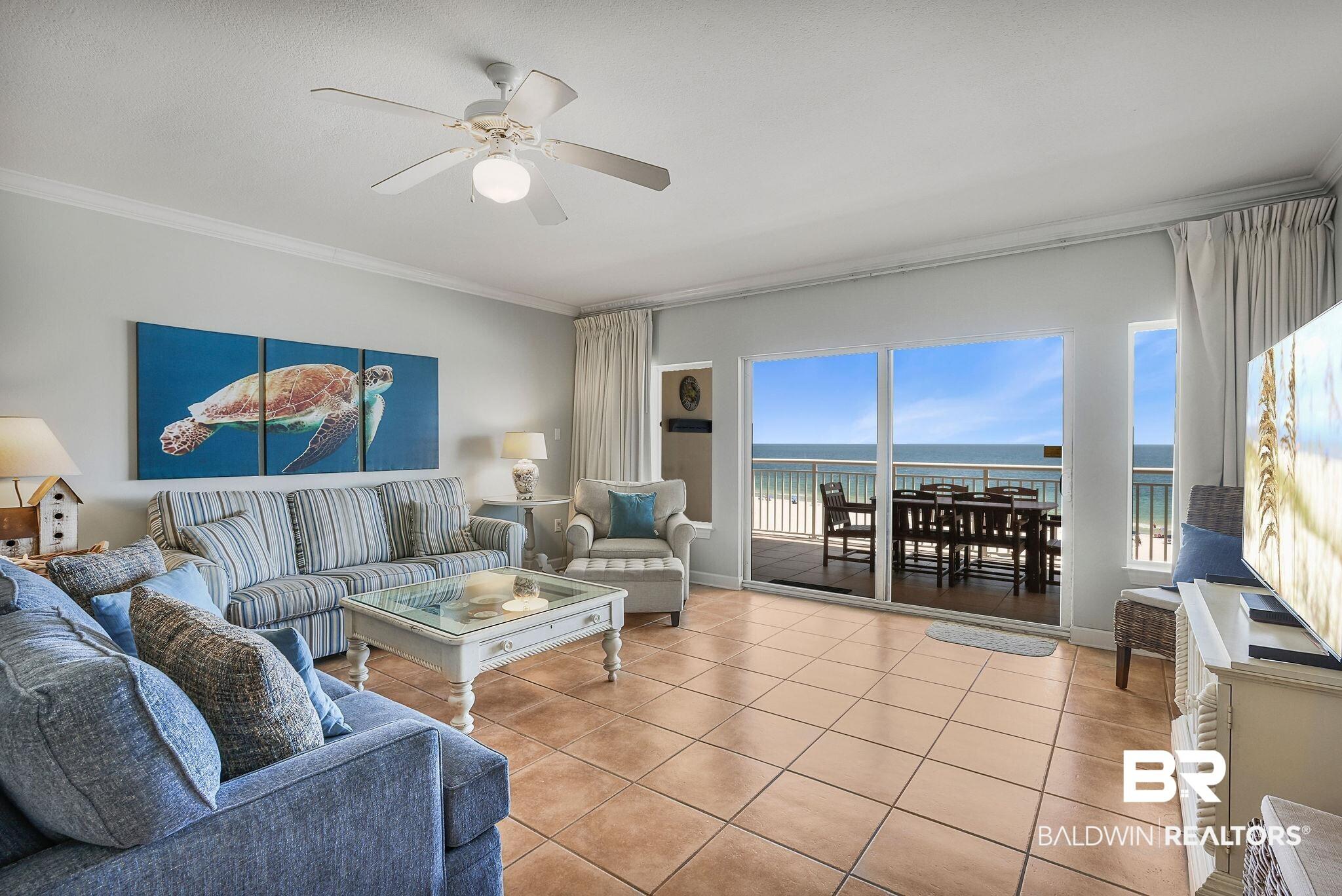 Image 2: Tiled living room with crown molding and ceiling fan