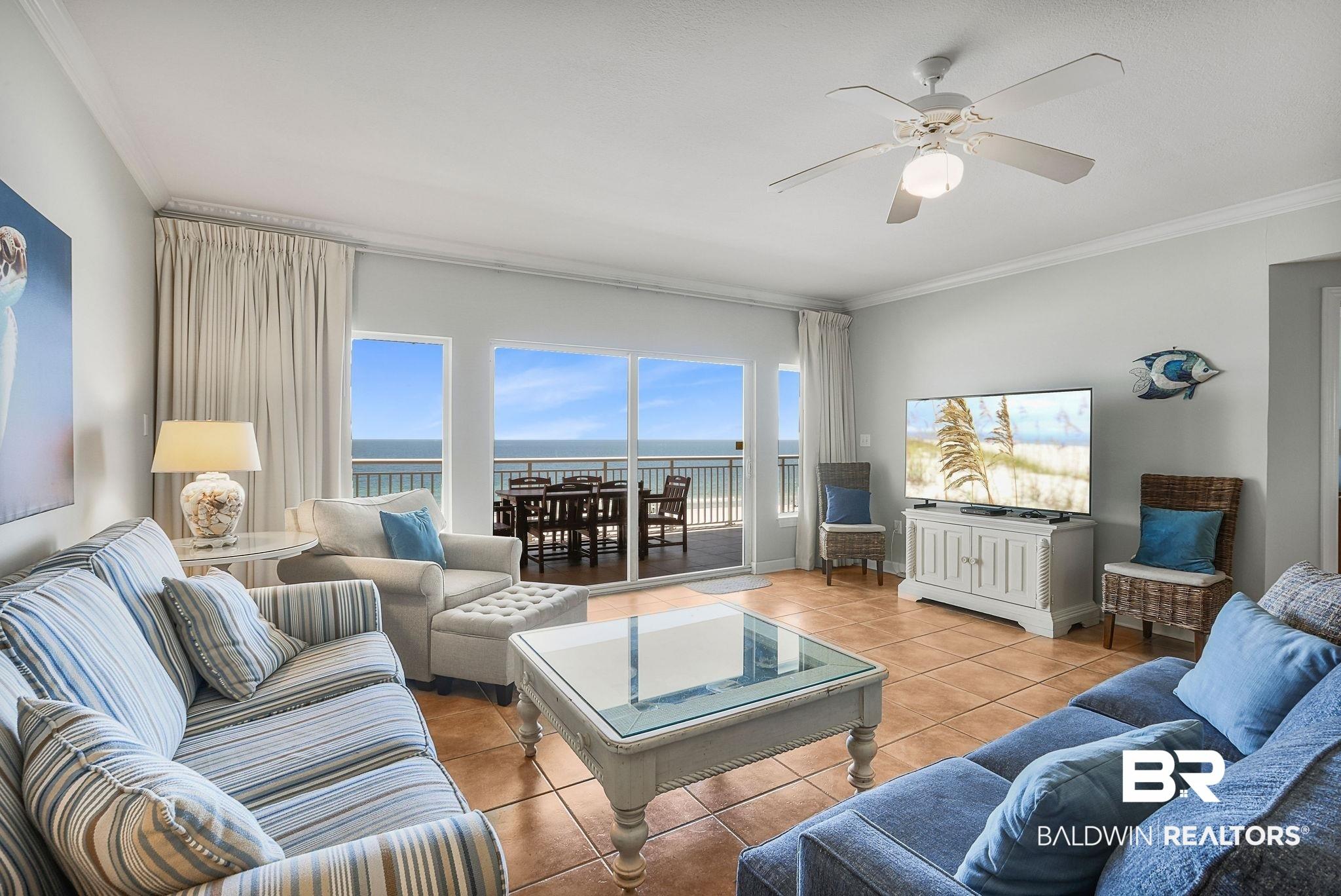 Image 3: Tiled living area featuring crown molding and ceiling fan