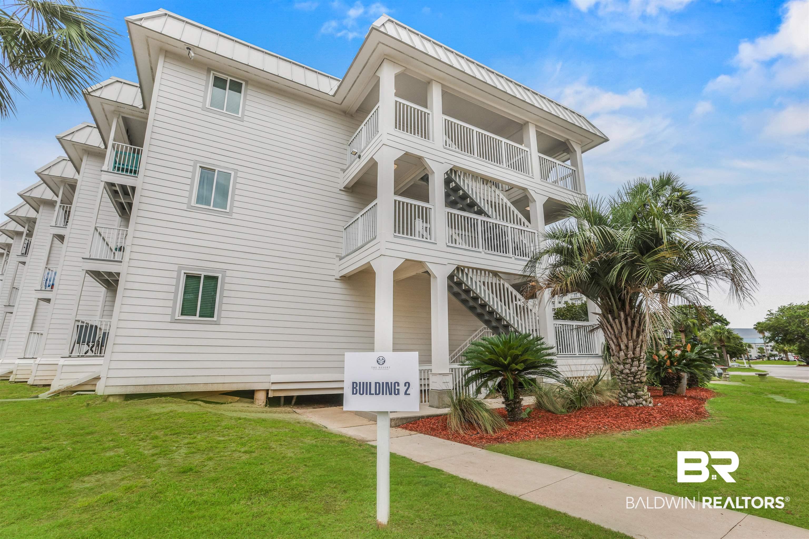 Image 1: Multi-story residential building featuring white horizontal siding and multiple private balconies with white railings