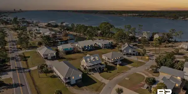 Image 2: Aerial view of property's location with a large body of water and nearby suburban area