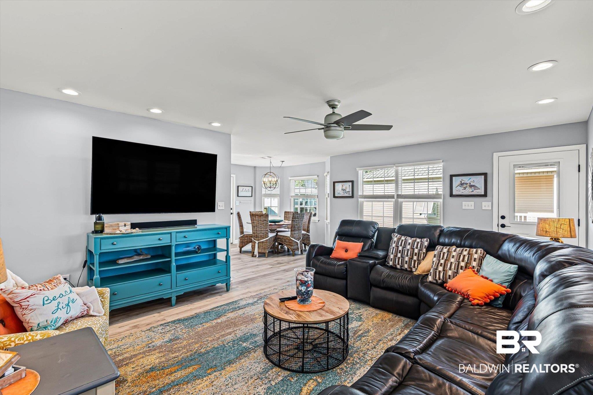 Image 4: Living room with recessed lighting, wood finished floors, and a ceiling fan