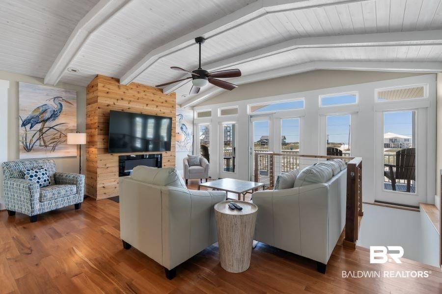 Image 4: Living room with ceiling fan, wood finished floors, wooden ceiling, and wooden walls