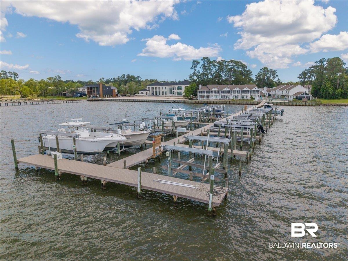 Image 2: Extensive private boat dock with multiple boat slips and lifts, composite decking, and wooden pilings