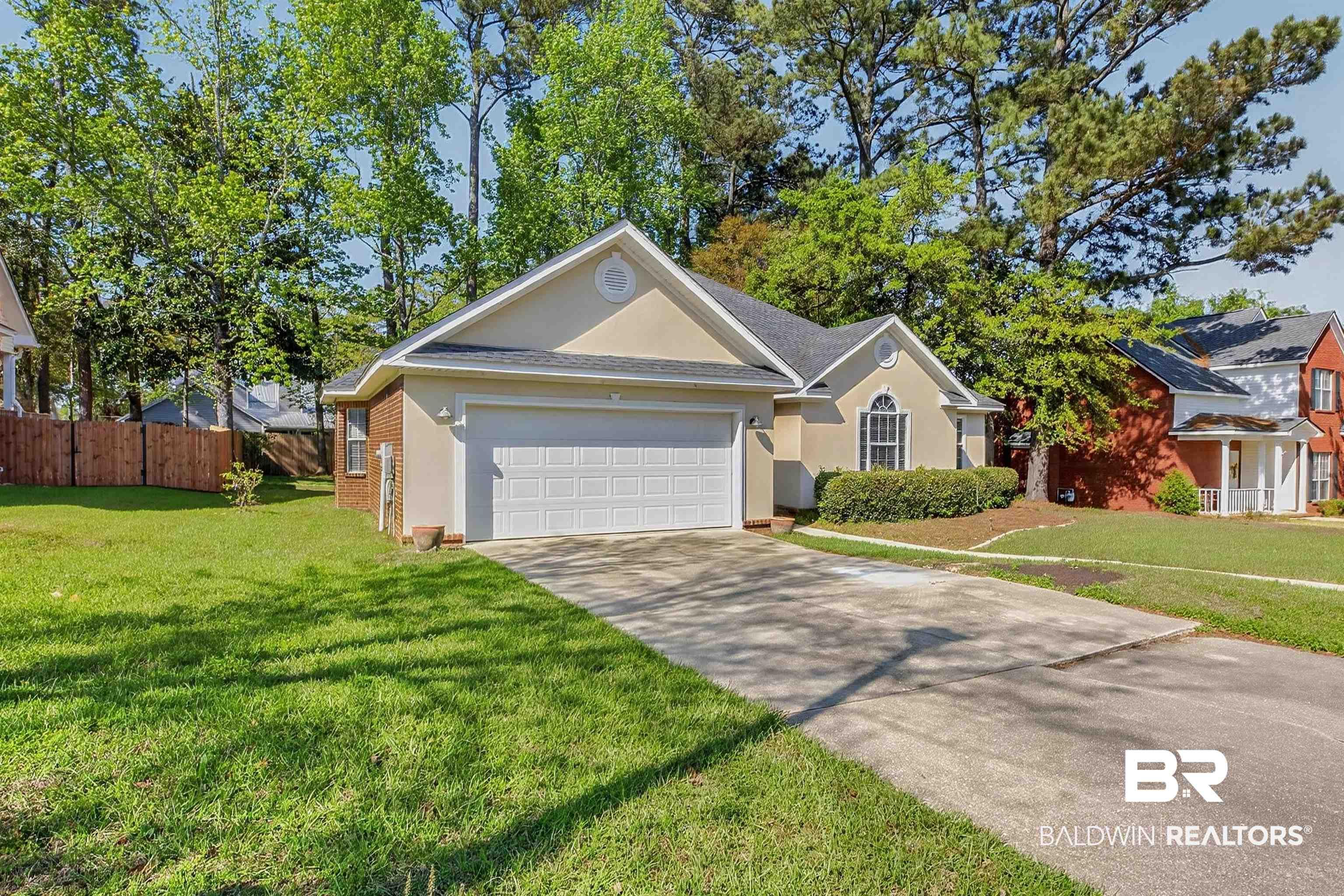 Image 2: Single-story residence featuring a stucco and brick exterior, a two-car garage, and a concrete driveway