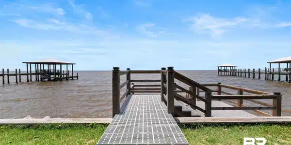 Image 3: Waterfront access with a private pier featuring a covered boat slip and additional open slips
