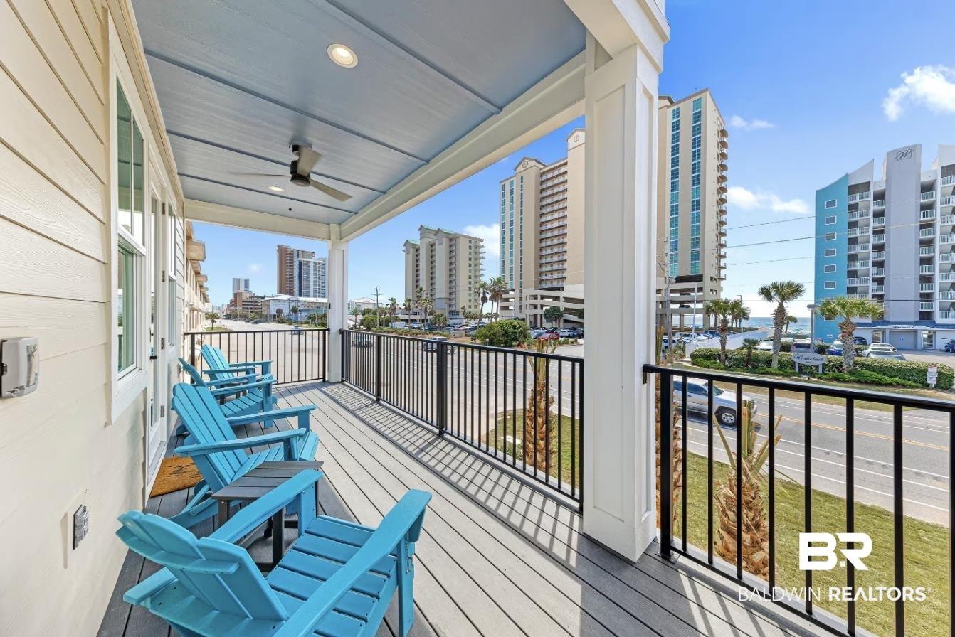 Image 1: Covered balcony featuring composite decking and black metal railings
