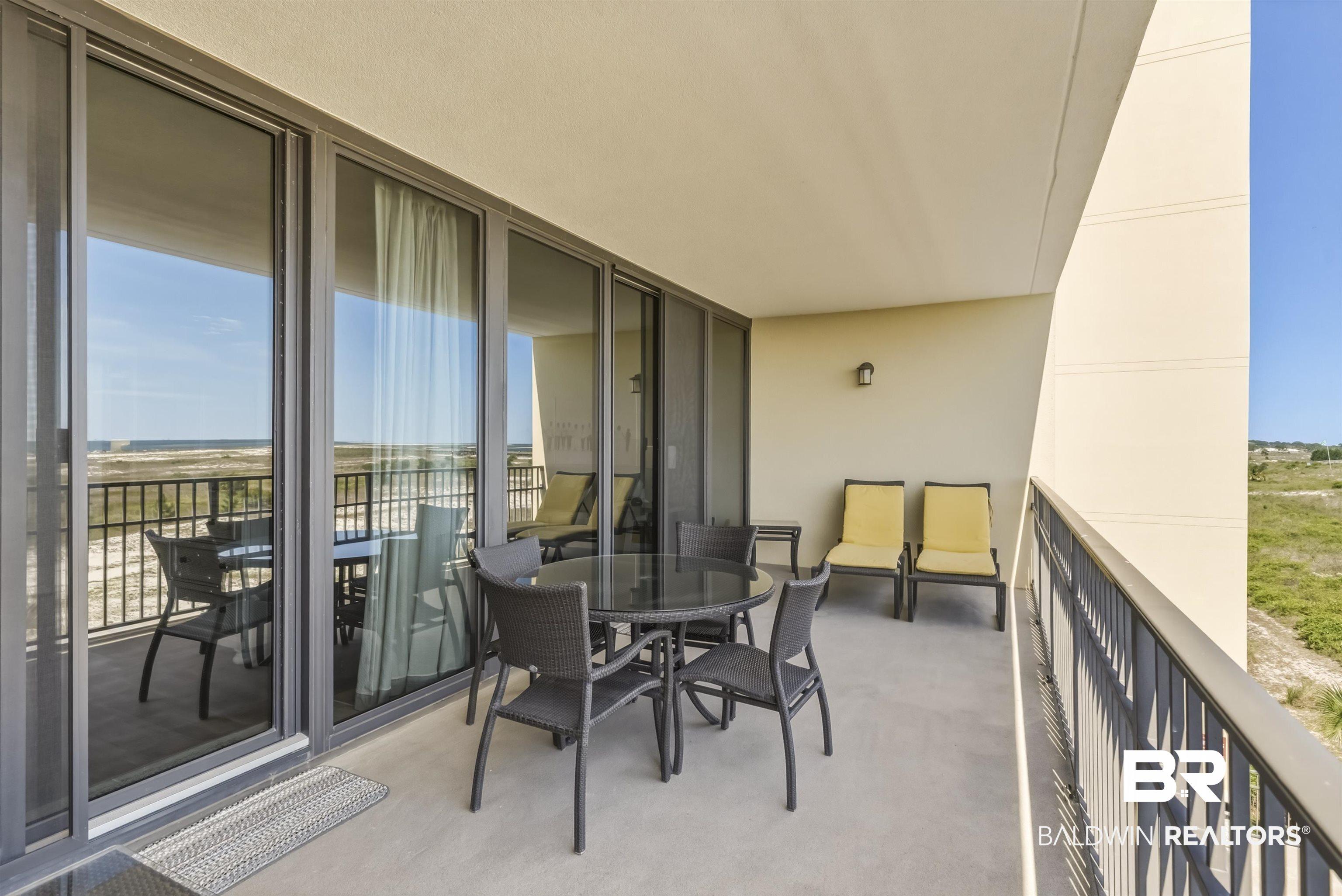 Image 4: Expansive private balcony featuring a concrete surface and a metal railing
