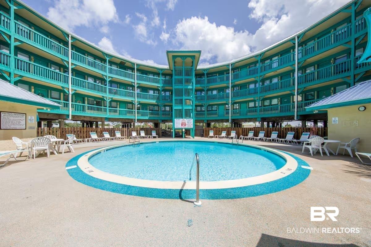 Image 1: Resort-style circular pool with a surrounding concrete deck