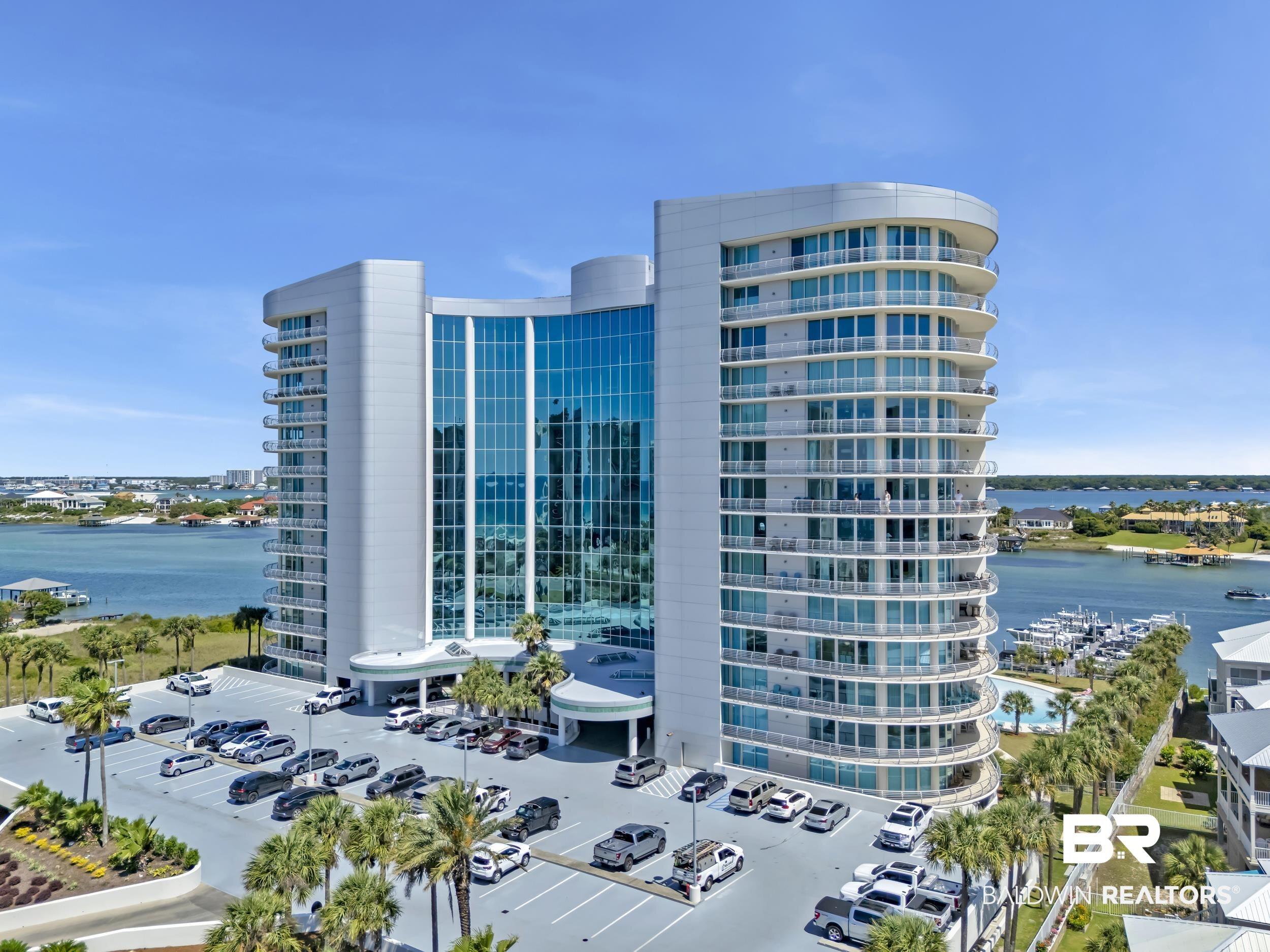 Image 3: Modern high-rise building featuring extensive glass curtain walls and curved balconies