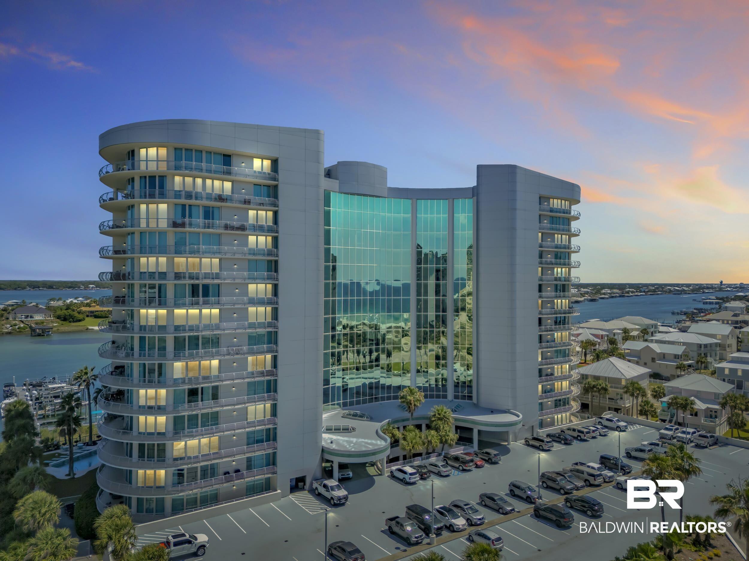Image 4: Modern multi-story building featuring expansive glass facades and individual balconies