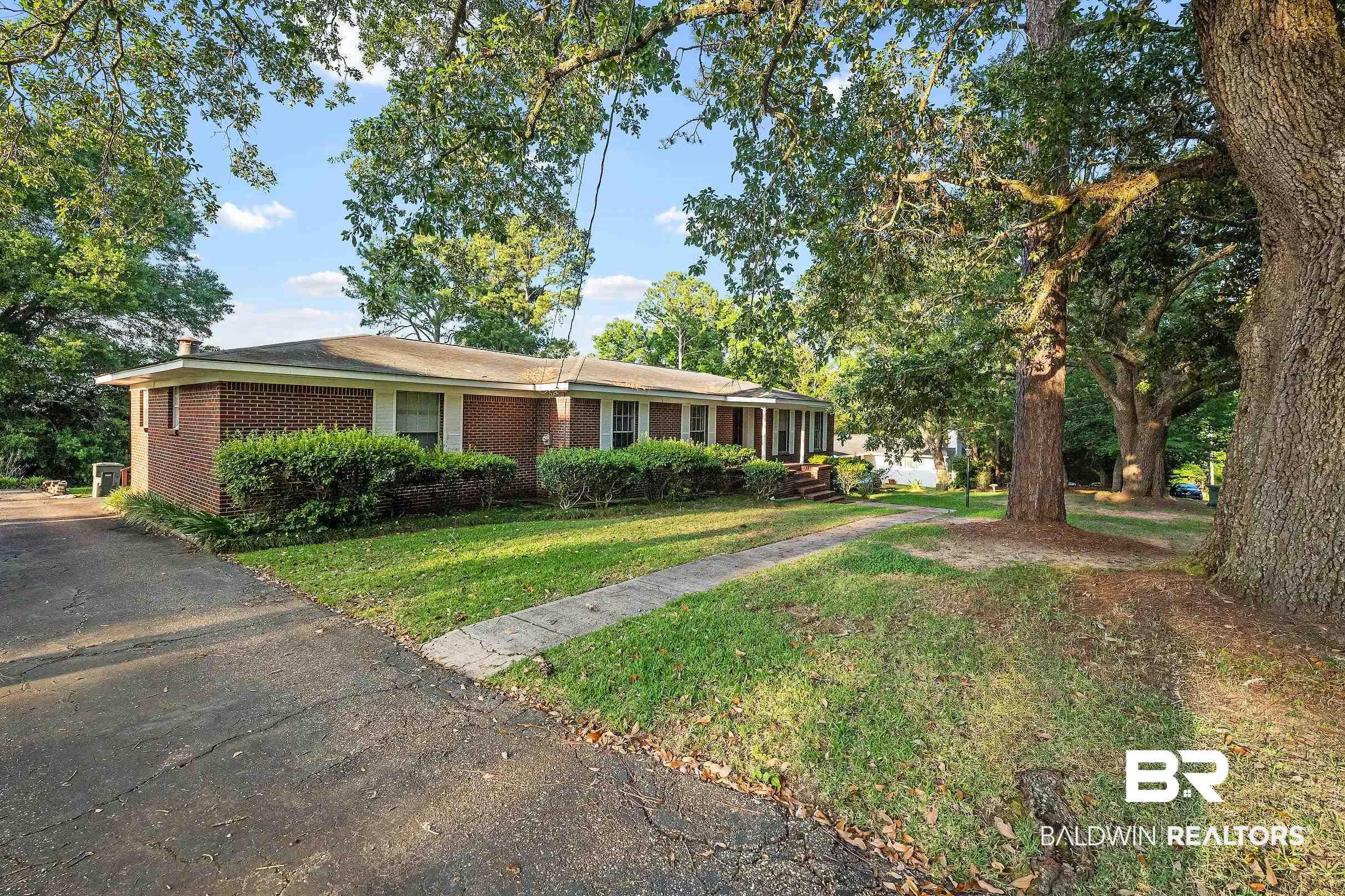 Image 2: Ranch-style residence featuring a brick exterior and a low-pitched roofline
