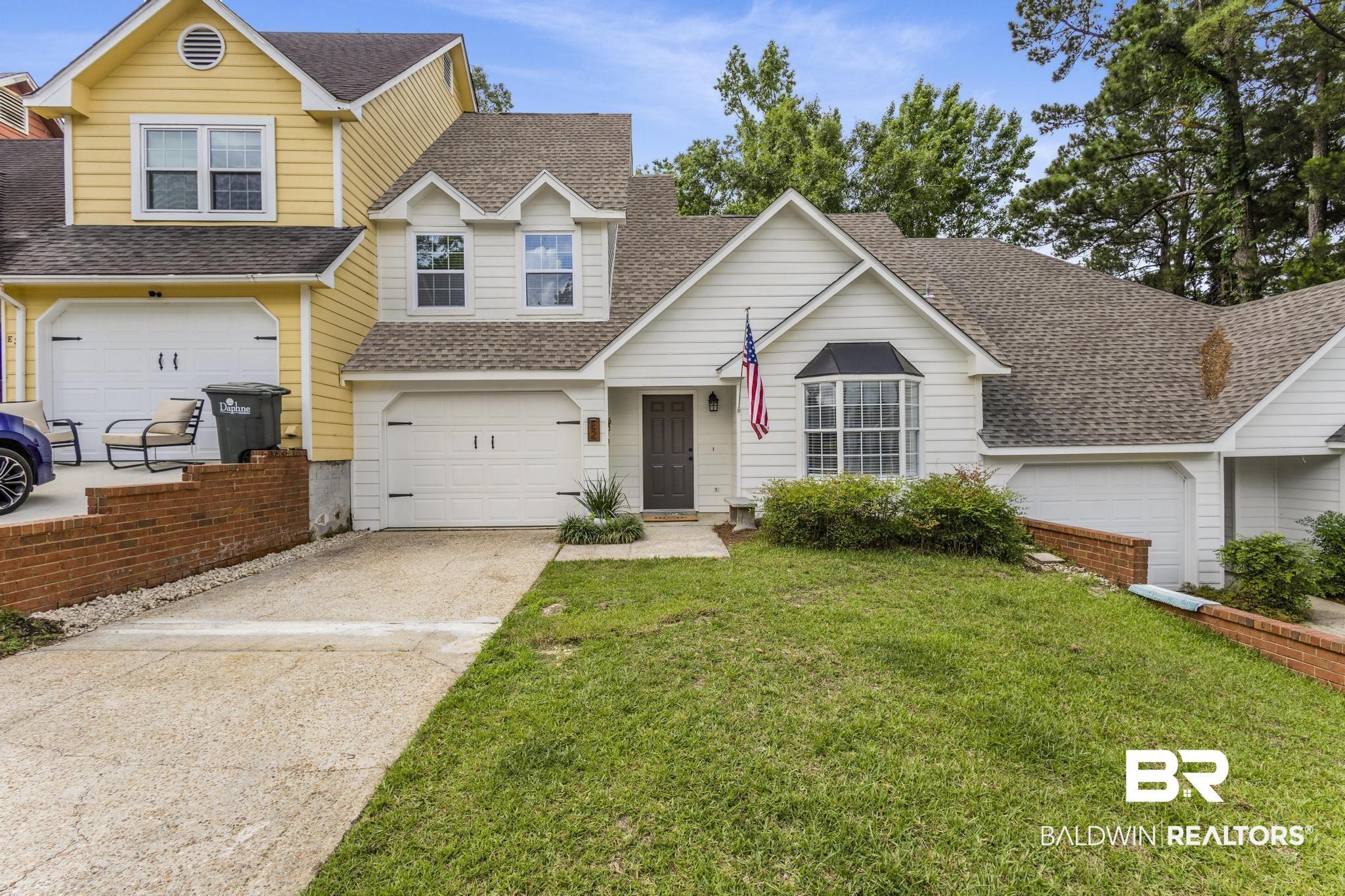 Image 2: Residential property featuring white siding and a prominent bay window